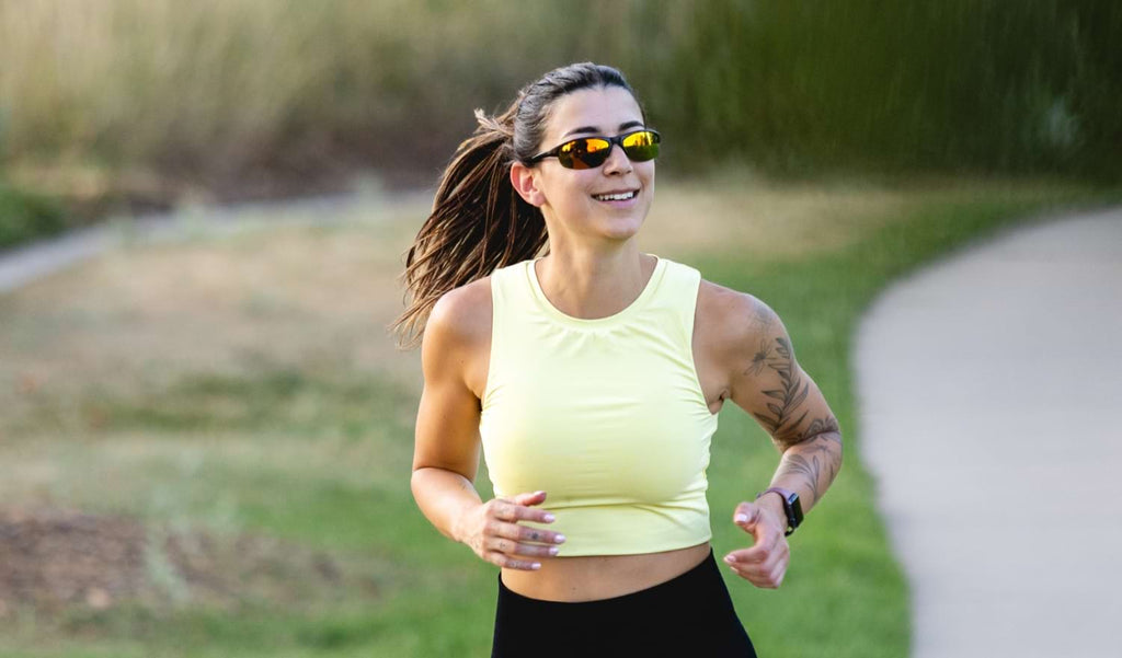 Woman running on a path wearing Optic Nerve Alpine sunglasses
