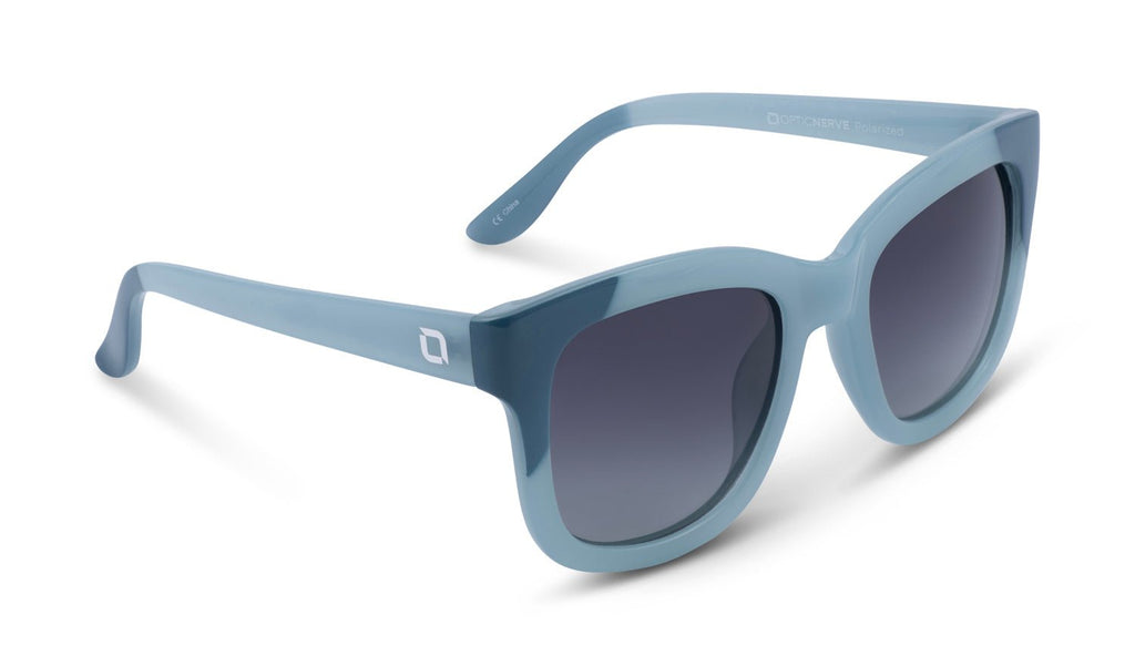 Optic Nerve Baby Doe sunglasses with a blue frame and a smoke lens on a white background