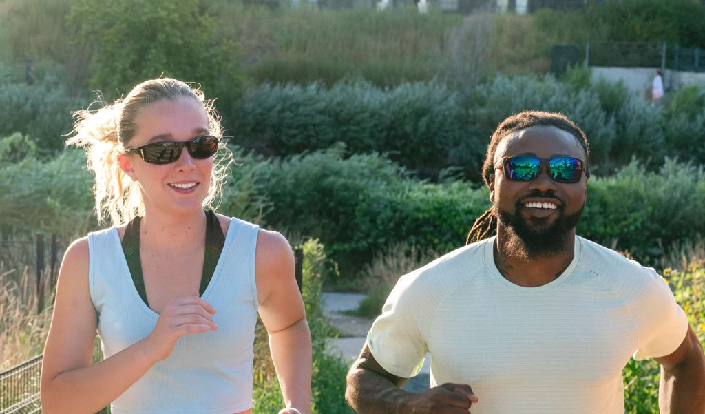 Two runners wearing Optic Nerve sunglasses with a natural background