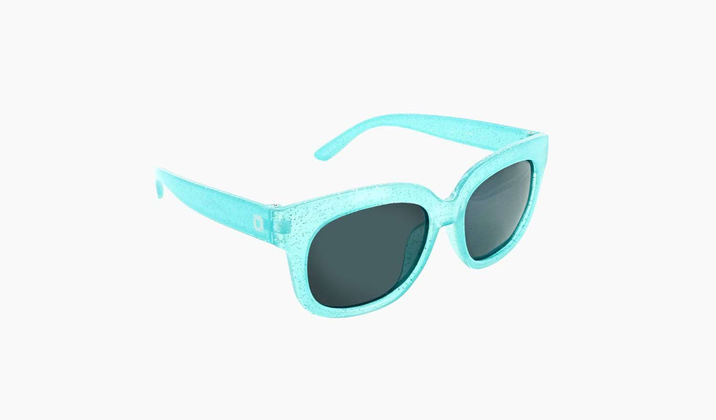 Optic Nerve Kids Tart sunglasses with a sparkle blue frame and smoke lenses on a white background