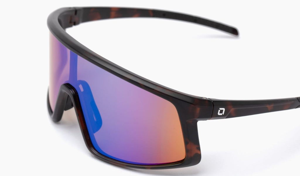 Optic Nerve Stone Cat sunglasses with a tortoise frame, brown lens, and green mirror with a white background